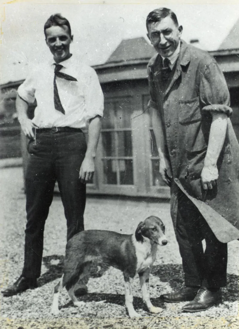Photograph of F.G. Banting and C.H. Best with a dog on the roof of the Medical Building
